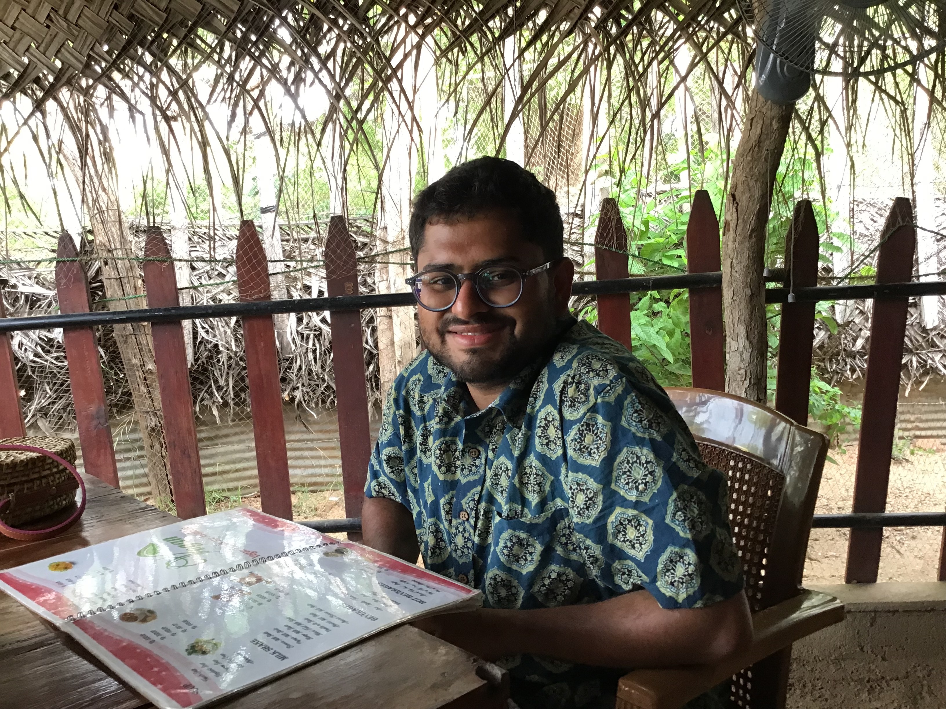 Archit sitting in a shack